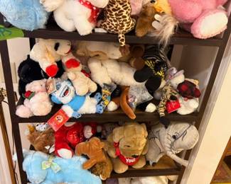 Wooden bookshelf filled with stuffed animals and plush toys collection