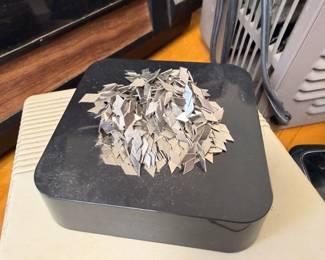 Decorative metal floral sculpture on black base, tabletop art