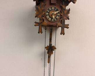 German Black Forest cuckoo clock with carved leaves and bird
