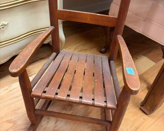 Vintage child's wooden rocking chair with slat seat