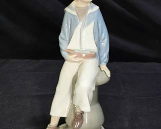 Lladró 4810 figurine, titled "Boy with Yacht"
