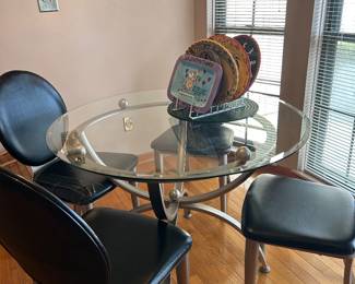 Round glass topped kitchen table with 4 chairs