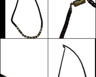 surfer-style necklace features a combination of black beads, possibly made from coconut wood or black coral, and white shell /bone heishi beads.
