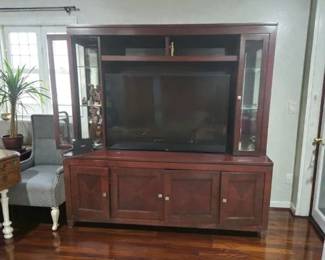 Very nice entertainment center modern for 55 in TV sides open and are lighted pull out drawers for storage