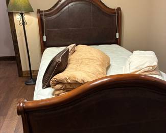 Arched leather and wood full-size bed frame, with full-sized Comfort Keepers mattress