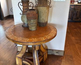 Round side table with decorative urns
