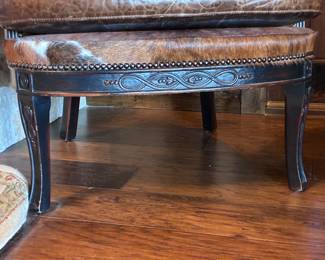 Two Western-style wingback chairs upholstered in top-grain tobacco leather, and one with brindle hair-on-hide.