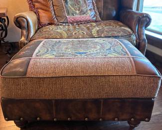 leather wing chair-and-a-half with a paisley fabric seat cushion and nailhead trim, by King Hickory.