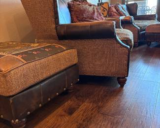 leather wing chair-and-a-half with a paisley fabric seat cushion and nailhead trim, by King Hickory.