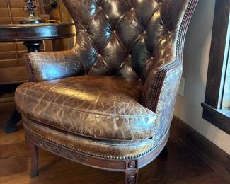 Two Western-style wingback chairs upholstered in top-grain tobacco leather, and one with brindle hair-on-hide.