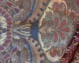 leather wing chair-and-a-half with a paisley fabric seat cushion and nailhead trim, by King Hickory.