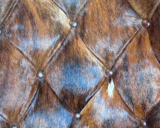 Two Western-style wingback chairs upholstered in top-grain tobacco leather, and one with brindle hair-on-hide.