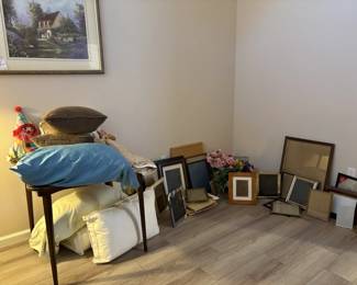 assortment of picture frames, pillows