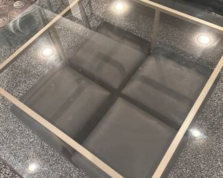 Contemporary glass table with four stools.