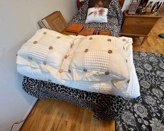 Neutral bedspread & pillows.