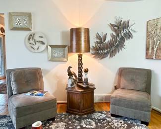 Two matching microsuede slipper chairs.