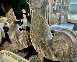 Hand carved wood stylized roosters.