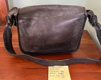 H48 - $100 Vintage 1970s Coach NYC Messenger Bag - Black Leather. Measures 10" wide x 4" deep x 9" tall. 