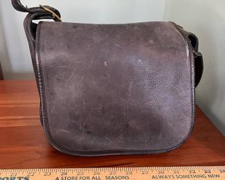 H48 - $100 Vintage 1970s Coach NYC Messenger Bag - Black Leather. Measures 10" wide x 4" deep x 9" tall. 