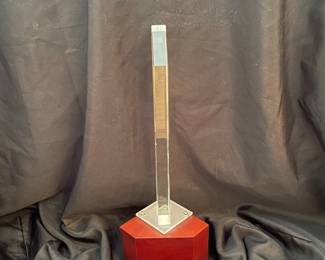 H95 - $100. "Harmonics Award" Column of Starphire Crystal designed by Susan Jacobs Lockhart in the spirit of Frank Lloyd Wright. Measures 15.5" tall. Etched on both sides showing various designs depending on viewpoint. Base has a hole and can be lighted. 
