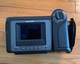 H43 - $25. Sharp Video Camera Model VL-E33U Case & Charger. 