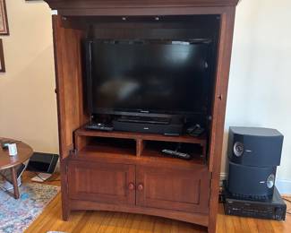 H56 - $50. Kincaid Media Cabinet. Doors slide inside for storage. Measures 48" wide x 23" deep x 62" tall. 