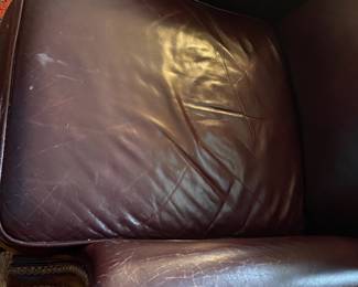 H27 - $30. Well loved leather recliner. Measures 32" wide x 31" deep x 39" tall. Cracking on arms.