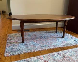 H57 - $75. Wooden Oval Coffee Table. Measures 54" long x 31.5" wide x 17.5" tall. With the leaves down it is 16.5" wide. 