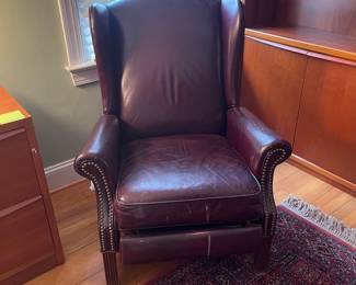 H27 - $30. Well loved leather recliner. Measures 32" wide x 31" deep x 39" tall. Cracking on arms.