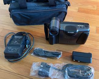 H43 - $25. Sharp Video Camera Model VL-E33U Case & Charger. 