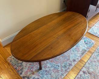 H57 - $75. Wooden Oval Coffee Table. Measures 54" long x 31.5" wide x 17.5" tall. With the leaves down it is 16.5" wide. 