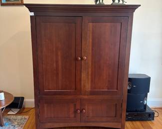 H56 - $50. Kincaid Media Cabinet. Doors slide inside for storage. Measures 48" wide x 23" deep x 62" tall. 