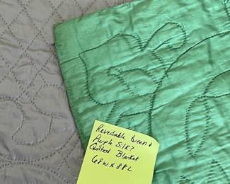 H53 - $85. Reversible Green & Purple Silk (?)  Quilted Blanket. Hand Quilted, Hand Sewn Binding. Measures 68" x 88". 