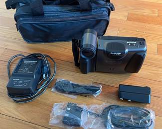 H43 - $25. Sharp Video Camera Model VL-E33U Case & Charger. 
