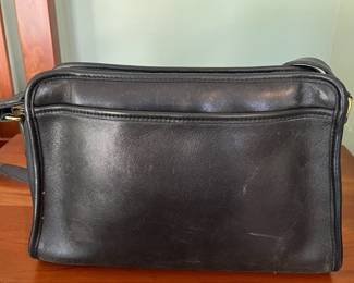 H44 - $70. 1980s Vintage Coach Taylor Black Leather Crossbody Bag. Measures 11.5" x 4" x 8" tall. 