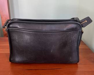 H44 - $70. 1980s Vintage Coach Taylor Black Leather Crossbody Bag. Measures 11.5" x 4" x 8" tall. 