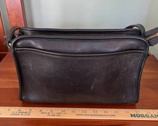 H44 - $70. 1980s Vintage Coach Taylor Black Leather Crossbody Bag. Measures 11.5" x 4" x 8" tall. 