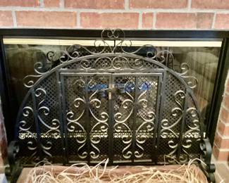 Wrought  fire screen with arch scrollwork and hinge doors