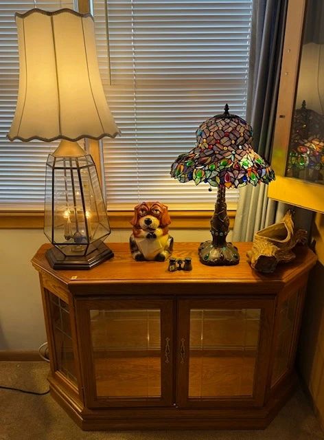Lighted curio cabinet. Tiffany style-stained glass table lamp.