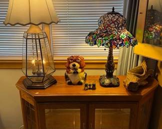 Lighted curio cabinet. Tiffany style-stained glass table lamp.