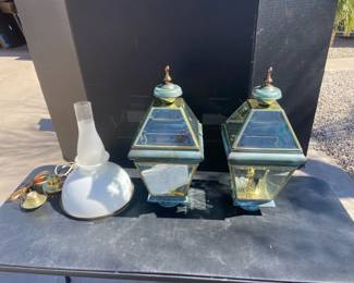 Two Lantern Light Fixtures And A Hanging Light Fixture 