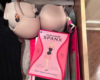 several unopened Spanx packages, undergarments, hosiery