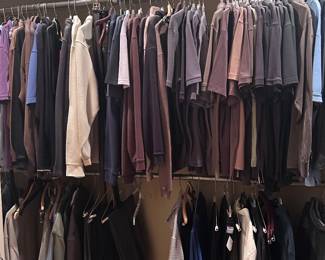 an entire men's closet with collared polo shirts, pants, suits, ties, shoes