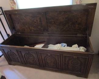 Antique carved chest currently filled with antique linens