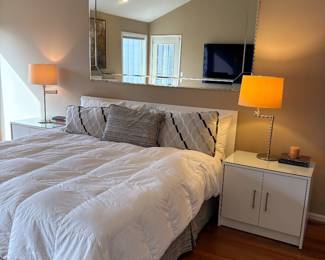 King bed (headboard, bed, and mattress set), matched set of nightstands with glass top, and swing arm lamps, and large mirror