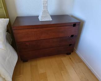 Dark wood 3-drawer dresser (note surface damage).