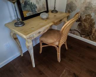 Distressed writing desk. French provincial style. Matches armoire listed elsewhere. Woven rattan chair sold separately.