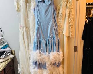 The white dress on the far left is a wedding dress (in clear bag)