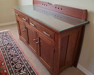 Solid cherry wood sideboard with glass top purchased at the Amish Furniture Gallery.