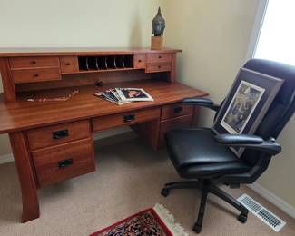 Cherry wood desk purchased from the Amish Furniture Gallery ; Lay-Z- Boy office chair.